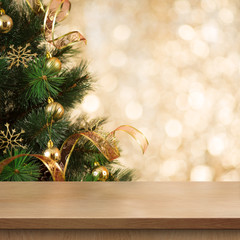 Christmas tree branch behind empty wood table or shelf