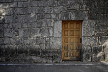 Old Wooden Door At Brick Stone Wall As Background
