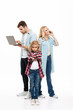 © Drobot Dean - Full length portrait of a family talking on mobile phone