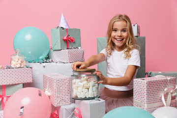 Wall Mural - Portrait of a little girl in a birthday hat celebrating