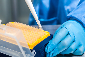 Scientist attaching a disposable tip to a micropipette