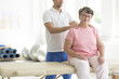Personal masseur massaging senior woman