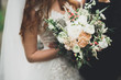 Luxury wedding bouquet in bride's and groom hands