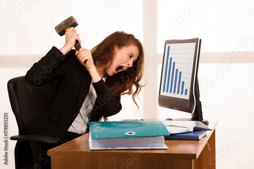 Fotografie, Tablou Angry business woman expressing rage at her desk in the office