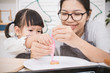 © paulaphoto - Portrait of little asian girl and her mother baking cake and cookies in the kitchen. Happy asian family and mother’s day concept