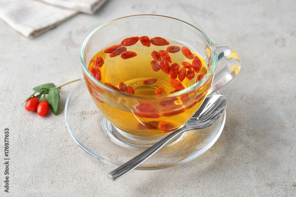 Cup with goji tea on table