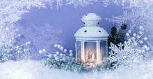 Christmas Eve Lantern And Decorations Background. Picture Of A White Lantern With Lighted Candle Decorated With Pine Cones  On A White Snow Against Red Frost Background
