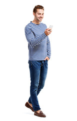 Sticker - Young handsome man using his mobile phone against white background