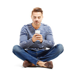 Sticker - Young handsome man with mobile phone against white background