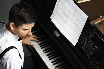 Poster - Young man playing piano indoors