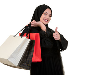 Arabian woman carrying shopping bags isolated on white