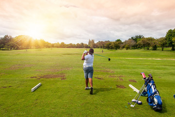 Sticker - 13-year-old Asian boy playing golf on a golf course in the sun