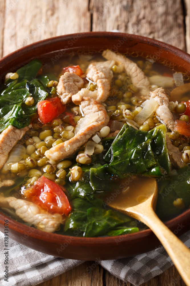 Munggo Guisado Filipino soup of beans mung closeup in a bowl. Vertical