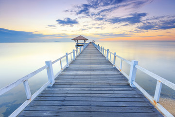 Old wood bridge pier  against beautiful sunset sky use for natural background ,backdrop and multipurpose sea scene