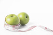 © NaMong Productions - green apple with measure tape on white background. concept nutrition healthy.