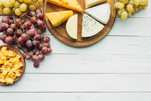 Various Types Of Cheese And Grapes