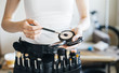 © galaganov - professional make-up artist with a belt bag with tassels. makeup brushes.