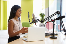 Young Mixed Race Woman Recording A Podcast In A Studio