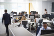 © Monkey Business - Man walking through a busy open plan office