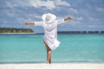 Free happy woman on beach enjoying nature. Natural beauty girl outdoor in freedom enjoyment concept.