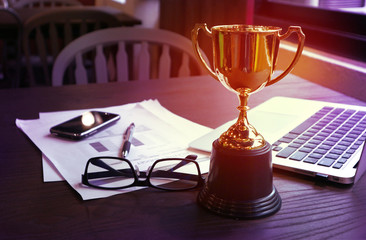 trophy on work table, win concept