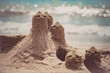 © Alfira - Sand castle standing on the beach. Travel vacations concept.