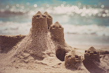 Sand Castle Standing On The Beach. Travel Vacations Concept.