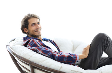 Wall Mural - successful guy sitting in a large round comfortable chair.