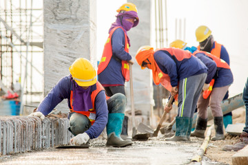 Wall Mural - Construction worker Concrete pouring during commercial concreting floors of building in construction site and Civil Engineer or Construction engineer inspec work