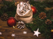 Beautiful Silver Christmas Decorations Spilling Out Of A Hessian Sack Ob A Wooden Background