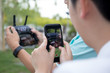 © bignai - Hand holding cell phone recording video at radio control drone