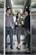 © DragonImages - Chatting in lift