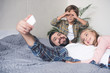 © LIGHTFIELD STUDIOS - father and kids taking selfie