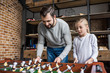 © LIGHTFIELD STUDIOS - father and daughter playing table football