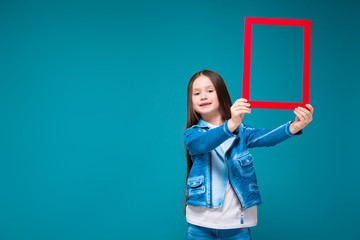 Pretty, little girl in azure coat with brunet hair