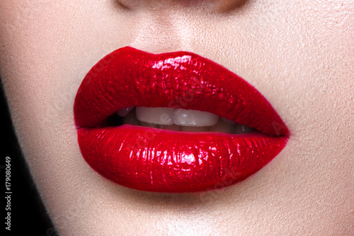 Foto Close up of woman lips with red lipstick.