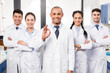 © LIGHTFIELD STUDIOS - Doctor with team showing ok sign