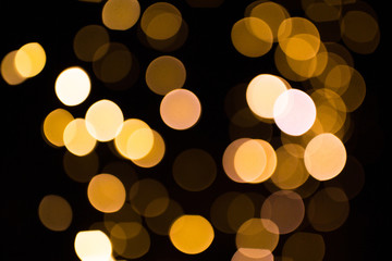 Wall Mural - blurred golden lights over dark background