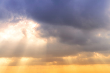 Wall Mural - sunset / sun rise sky with rays of yellow and red light shining clouds and sky background and textur