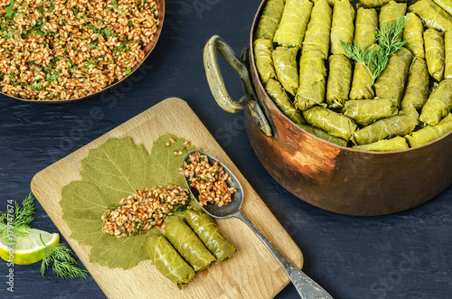 Fotografía Middle-Eastern Food, Arabian cuisine, preparing stuffed vine leaves, or traditional Dolma