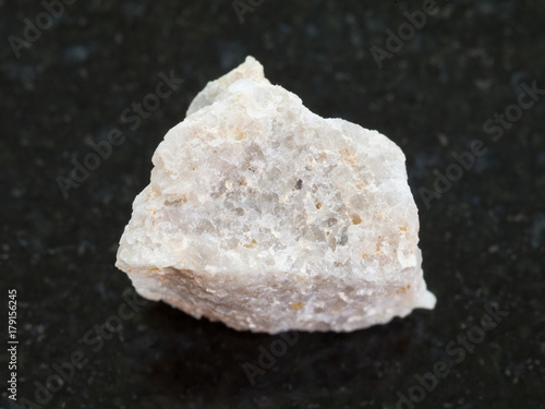 Fotografering raw Conglomerate stone on dark background