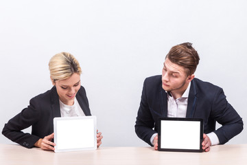 Picture of team of office workers both holding tablet