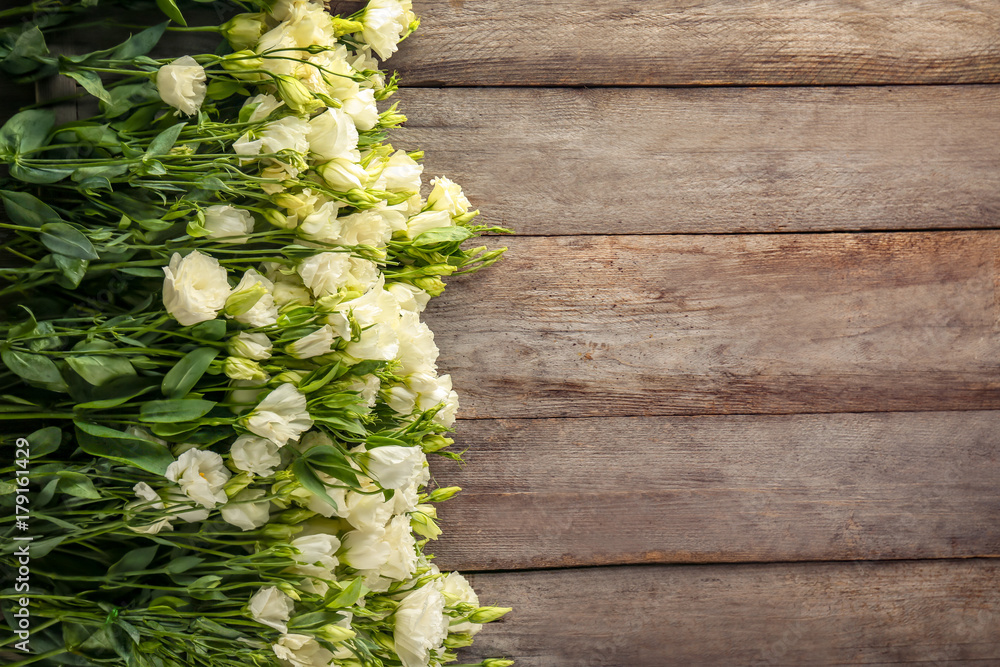 Beautiful eustoma flowers on wooden background