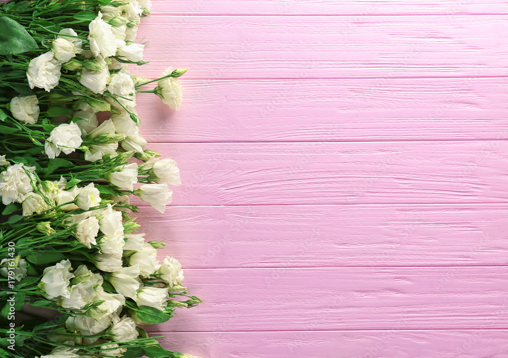Beautiful eustoma flowers on wooden background
