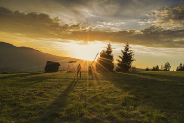 Girl silhouette at the sunrise on Durbaszka mountain in Poland. Sunrise in the mountains