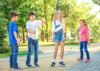 Wall Mural - Cute little children jumping rope in park