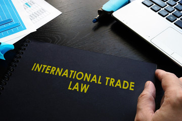 Wall Mural - International trade law and notebook on a table.