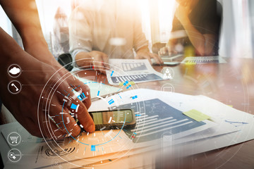 Poster - Hands of businessman using mobile phone in modern office with laptop and digital tablet computer in team meeting with VR icon diagram