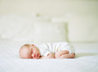 © Marta Locklear/Stocksy - Newborn baby sleeping on his belly on a bed