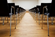© Mellimage/Stocksy - Row of chairs in empty convention room